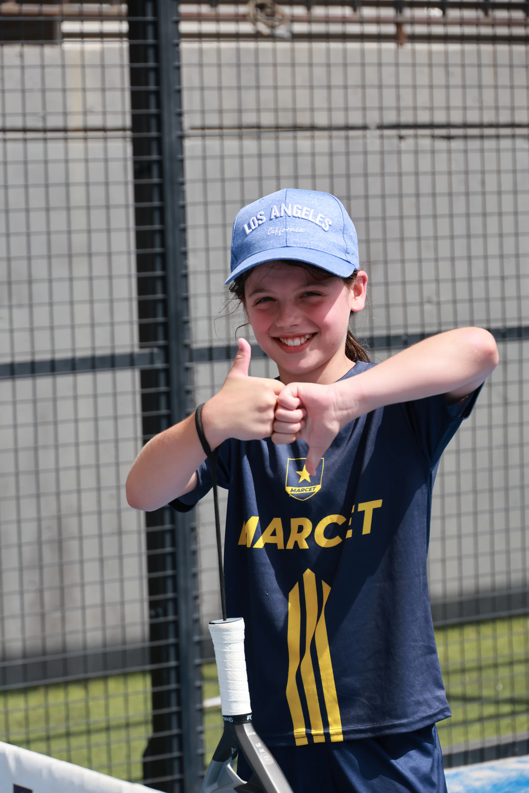 A Marcet player makes the OKKO sign with one thumb up and one down